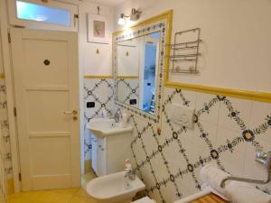 a bathroom with a sink and a mirror at Piccola Perla in Amalfi