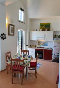 a kitchen with a table and chairs and a dining room at Piccola Perla in Amalfi