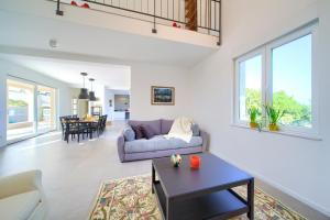 a living room with a couch and a table at Villa Olivia in Vrh
