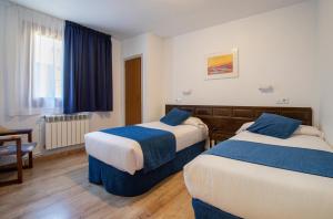 Postel nebo postele na pokoji v ubytování Hotel Marxant