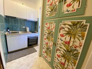 a kitchen with a floral wallpaper on the wall at Urban Rome Musei Vaticani in Rome