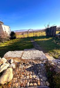 a walkway with rocks and a fence in a field at La Terrasse du Salève in Péron