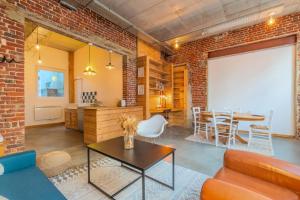 - un salon avec un mur en briques et une table dans l'établissement 2 bedroom souplex apartment with terrace, à Lille