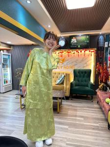 a woman standing in front of a store at SS Grey Hotel in Kuala Lumpur