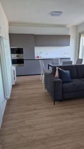 a living room with a couch and a kitchen at Cozy flat in Rome in Rome