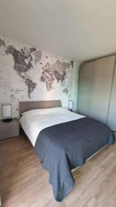 a bedroom with a large bed with a map on the wall at Cozy flat in Rome in Rome