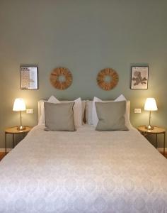 une chambre avec un grand lit blanc avec deux lampes dans l'établissement Tesa2 Casa Vacanze, à Trieste