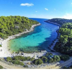 an aerial view of a beach with blue water at Apartments Tanja in Zavalatica