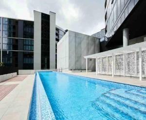 a swimming pool on the roof of a building at Luxe Apartment in Belconnen