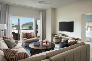 a living room with a couch and a tv at The Ritz-Carlton St. Thomas in Nazareth