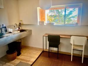 a kitchen with a table and two chairs and a window at Togaku Hokosha Female -over16 years old- Only Guest House - Vacation STAY 15724 in Nagano