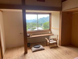 a room with a window with a chair and a desk at Togaku Hokosha Female -over16 years old- Only Guest House - Vacation STAY 15724 in Nagano