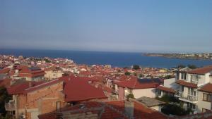 a view of a city with houses and the ocean at Guest House Polikseni in Sozopol
