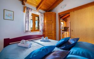 a bedroom with a bed with blue pillows at Eco holiday house Cive in Korčula