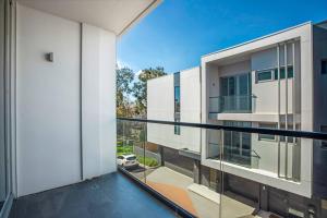 an apartment balcony with a view of a building at Retro Modern with Pool near Westfield Doncaster in Doncaster