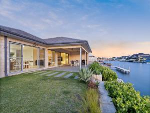 a house with a view of the water at Mariner's Cove Luxury Canal Home in Mandurah