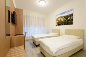 Letto o letti in una camera di Hotel Ceresio