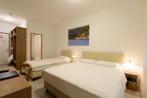 Letto o letti in una camera di Hotel Ceresio