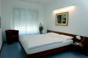 Letto o letti in una camera di Hotel Ceresio