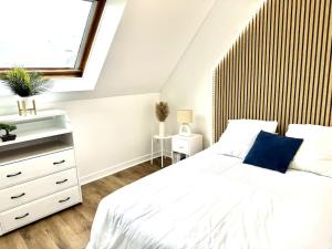 a bedroom with a white bed and a window at MARNELLY Maison Ploemeur 4 adultes et 1 enfants avec jardin privatif exposé sud in Ploemeur
