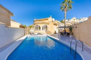 a swimming pool in front of a house at The Big Chill by Fidalsa in Ciudad Quesada