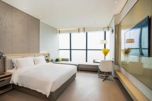 Postel nebo postele na pokoji v ubytování Wyndham Foshan Nanhai + 35 fotografií