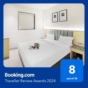 a hotel room with two beds in a room at FabHotel Oasis Yellow Courtyard in Bhopal