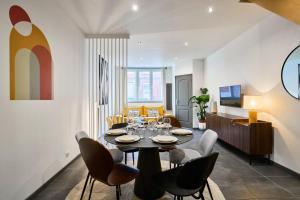 a dining room with a table and chairs at 3 bedroom house with courtyard, near metro in Tourcoing