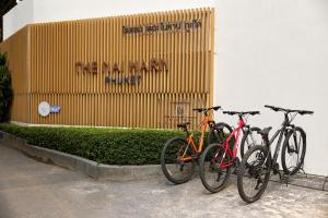 three bikes parked in front of a building at The Nai Harn in Nai Harn Beach