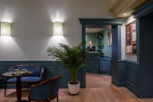 a man sitting at a counter in a waiting room at Hotel Montecarlo in Rome