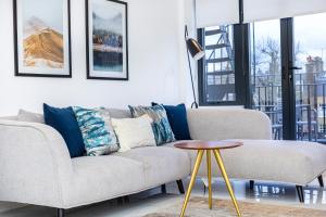 a living room with a couch and a table at Luxury Harley Street Apartments in London