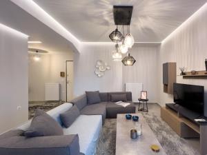uma sala de estar com um sofá e uma televisão em Anagnostopoulou Elegance 97sqm in Kolonaki em Atenas
