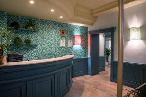 a bar in a room with a blue wall at Hotel Montecarlo in Rome