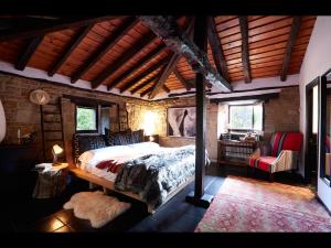 a bedroom with a bed and a chair in a room at Molino Tejada in Polientes