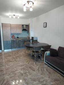 a living room with a table and a couch at Bella Costa in Dobra Voda