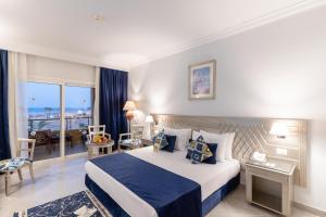 a hotel room with a bed and a balcony at Malikia Resort Abu Dabbab in Abu Dabbab