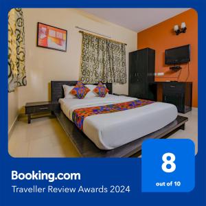 a hotel room with a bed and a tv at FabHotel New kolkata Residency Inn in Kolkata