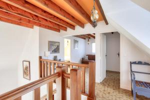 a staircase in a house with wooden beams at Parenthèse familiale entre plages et golf in Pléneuf-Val-André