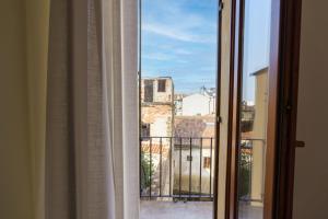 an open window with a view of a city at Residenza Marconi - Domus Verona in Verona