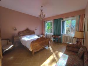 a bedroom with a large bed and a couch at ImaginaSoi in Dunières
