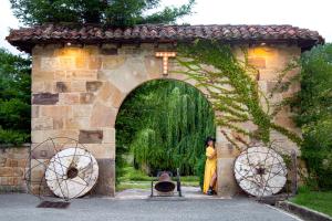 a woman standing in a stone archway with a woman in a yellow dress at Molino Tejada in Polientes
