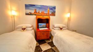 Dos camas en una habitación de hotel con dos ositos de peluche. en Íberos Royal en La Zubia