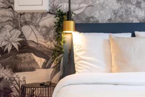 1 dormitorio con 1 cama y papel pintado con motivos florales en Lille Center - Nice studio, en Lille