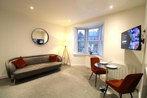 a living room with a couch and a table at No 10 @Short Stays in Basingstoke
