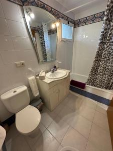 a bathroom with a toilet and a sink and a shower at Neptuno View 22 in Benidorm