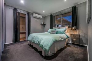- une chambre avec un grand lit et une fenêtre dans l'établissement Modern Stylish House in Craigie, à Perth