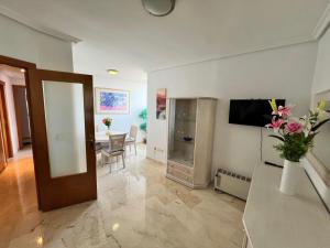 a living room with a television and a vase of flowers at Neptuno View 22 in Benidorm