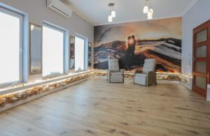 a room with two chairs and a painting on the wall at Apartamenty Ty i Ja in Grodziec