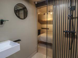 a bathroom with a glass shower and a sink at 8 Oak Cottages in Lancaster +9 photos