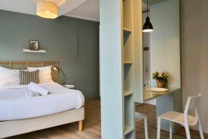 a bedroom with a bed and a desk and a chair at Lille Train station nice studio in Lille